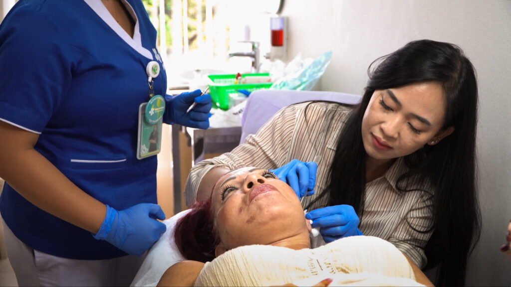 Nurse cleaning a surgical wound during a post-operative check